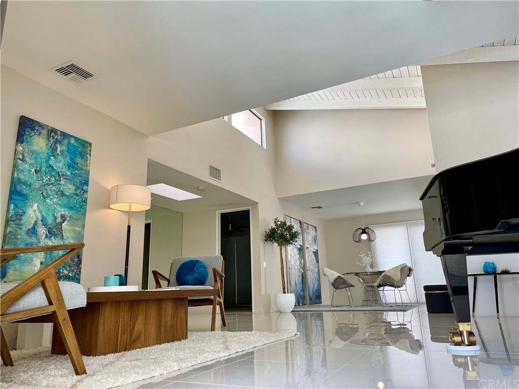2011 Normandy Court Palm Springs, CA 92264 - Photo 1 of 1 a living room with furniture and a flat screen tv