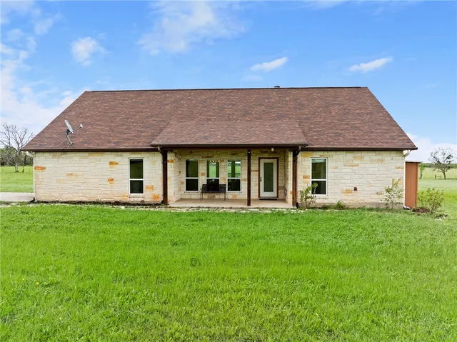 a view of a house with a backyard