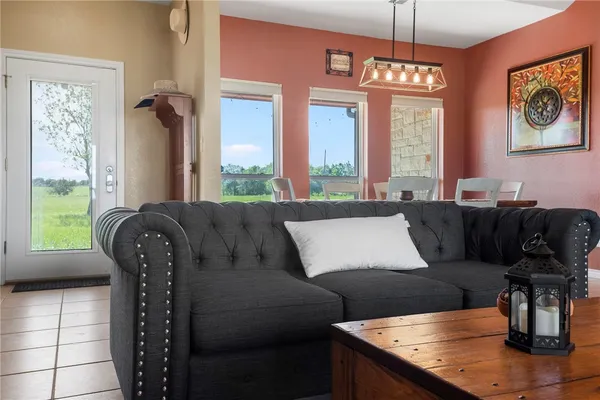 a living room with furniture and a chandelier