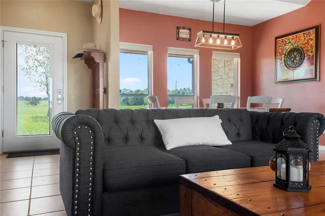 a living room with furniture and a chandelier