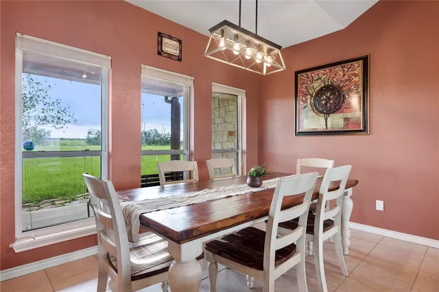a view of a dining room with furniture wooden floor and garden view
