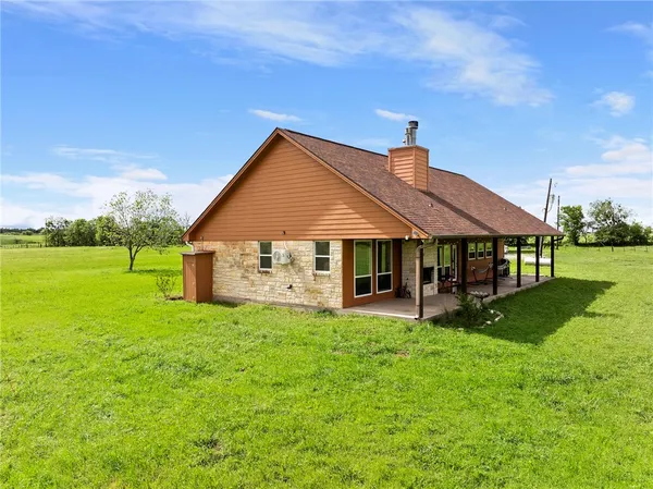 a big house with a big yard and large trees