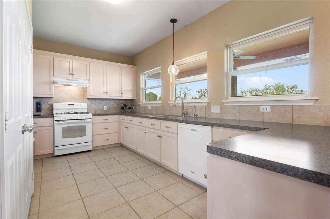 144 County Road 151 Riesel, TX 76682 - Photo 22 of 50 a kitchen with stainless steel appliances cabinets a sink and a large window
