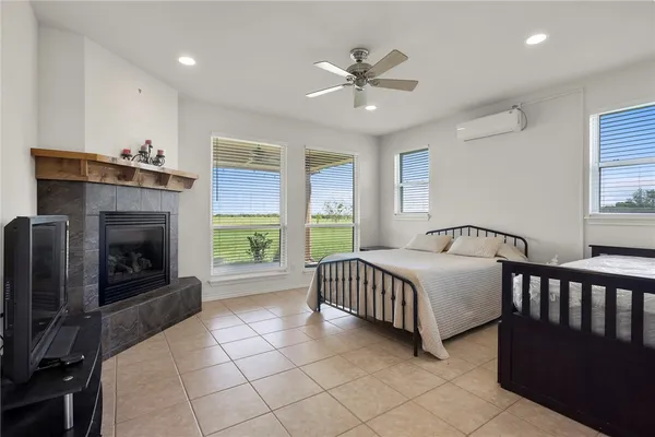 a spacious bedroom with a bed and a fireplace