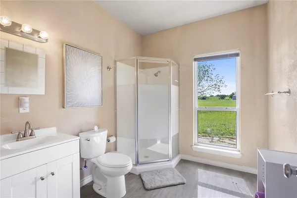 a bathroom with a toilet sink and a mirror