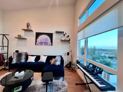 a living room with furniture and a floor to ceiling window