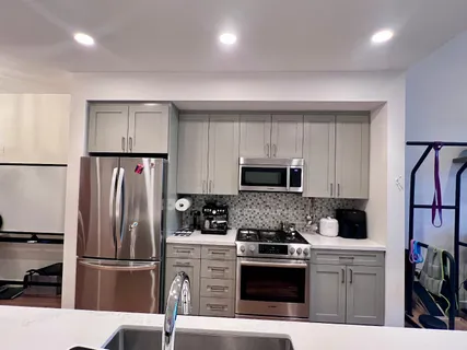 a kitchen with stainless steel appliances a refrigerator stove microwave and sink