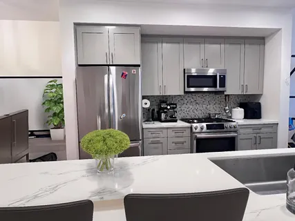 a kitchen with stainless steel appliances a refrigerator sink and stove