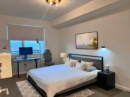 a bedroom with a bed and a desk