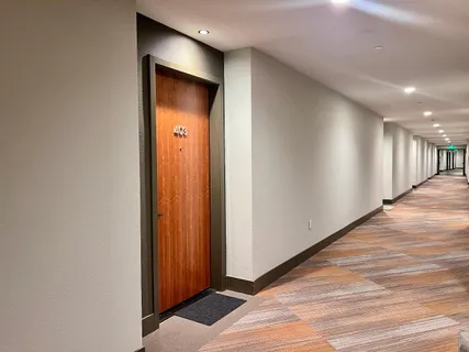 a view of a hallway with wooden floor