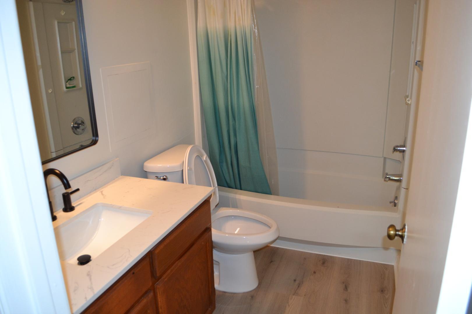4018 The Oaks Drive Raleigh, NC 27606 - Photo 23 of 49 a bathroom with a sink a toilet and shower