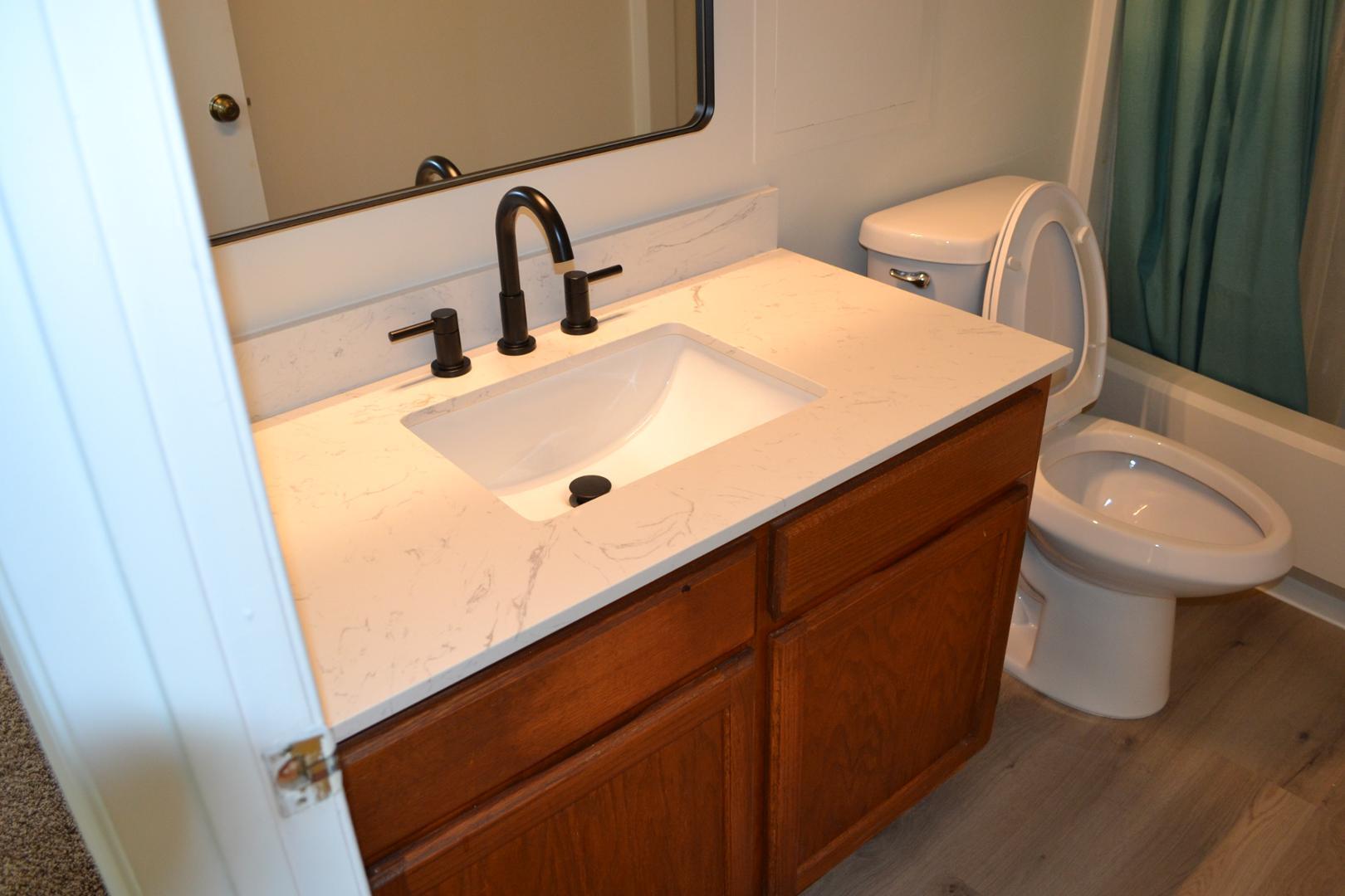 4018 The Oaks Drive Raleigh, NC 27606 - Photo 24 of 49 a bathroom with a sink and a toilet