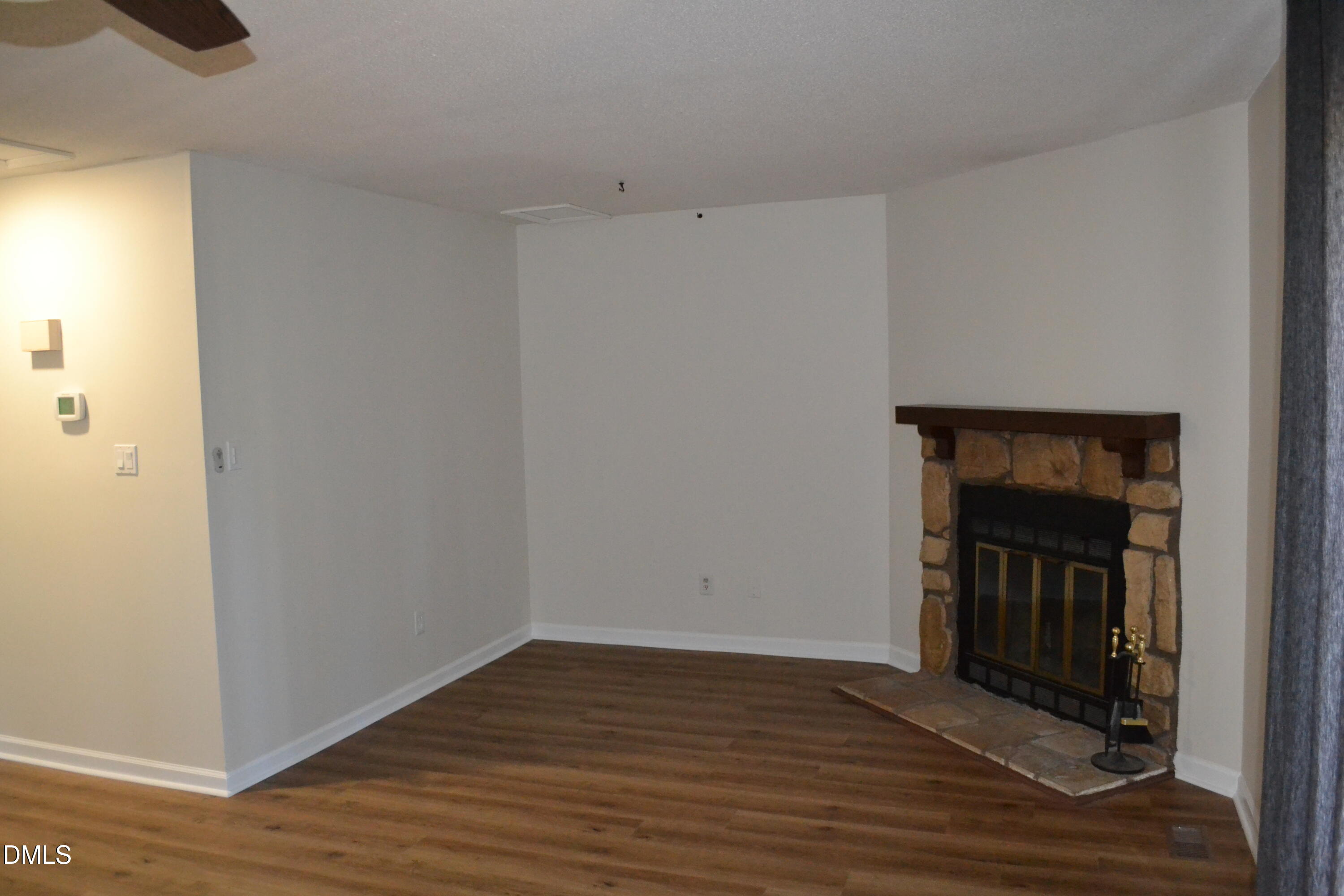 4018 The Oaks Drive Raleigh, NC 27606 - Photo 26 of 49 a view of an empty room with wooden floor and a window