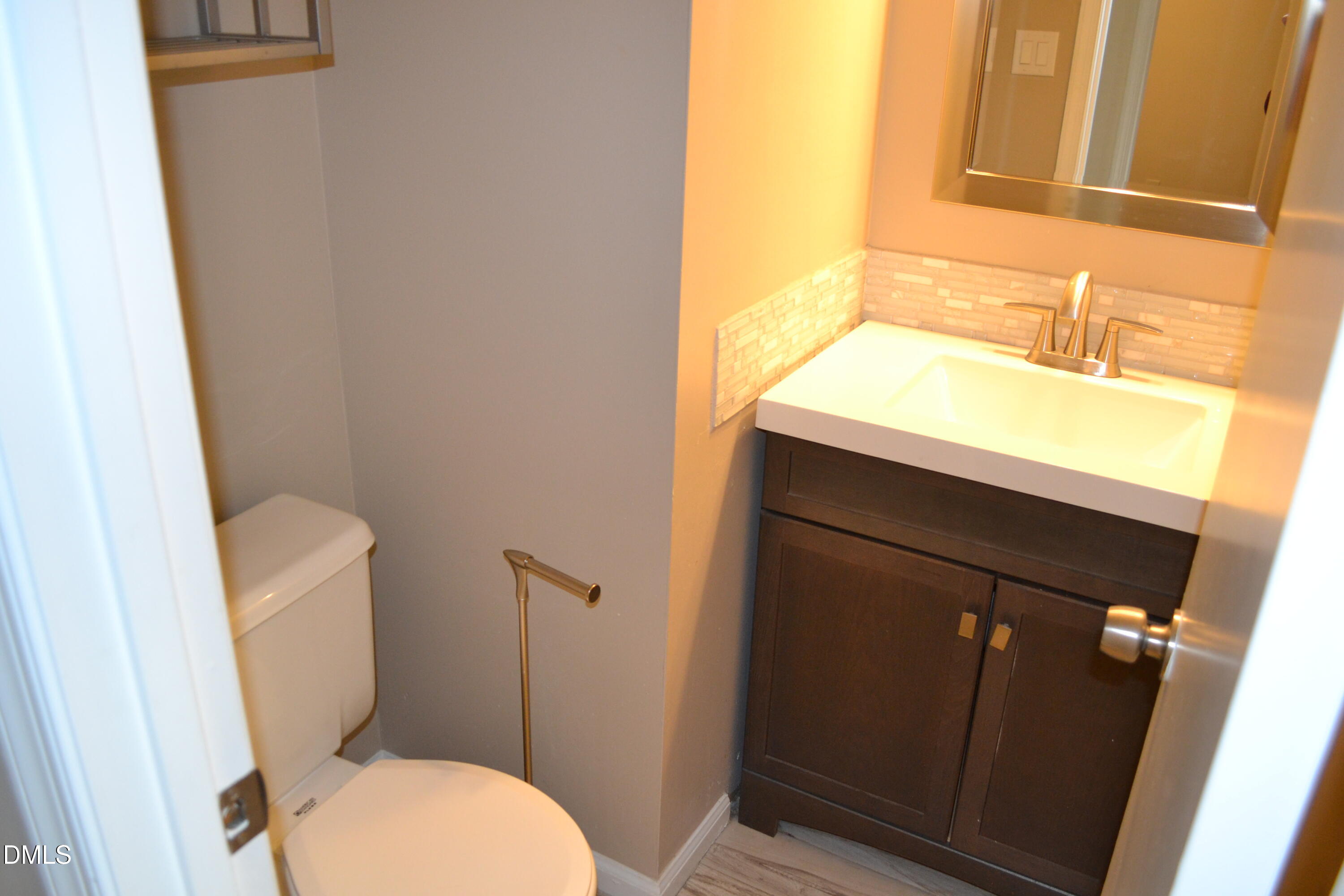4018 The Oaks Drive Raleigh, NC 27606 - Photo 30 of 49 a bathroom with a sink and a mirror