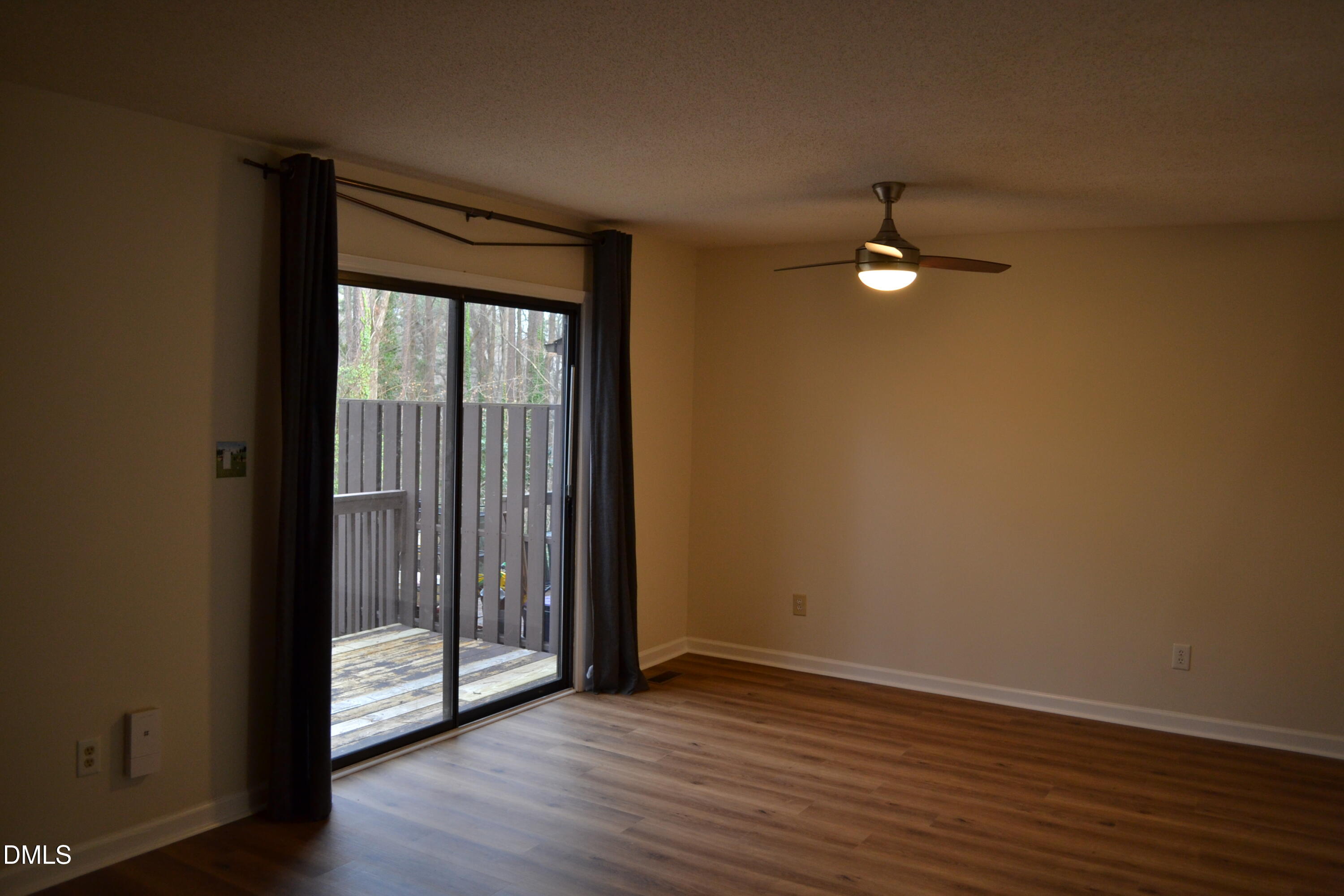 4018 The Oaks Drive Raleigh, NC 27606 - Photo 31 of 49 an empty room with wooden floor fan and window