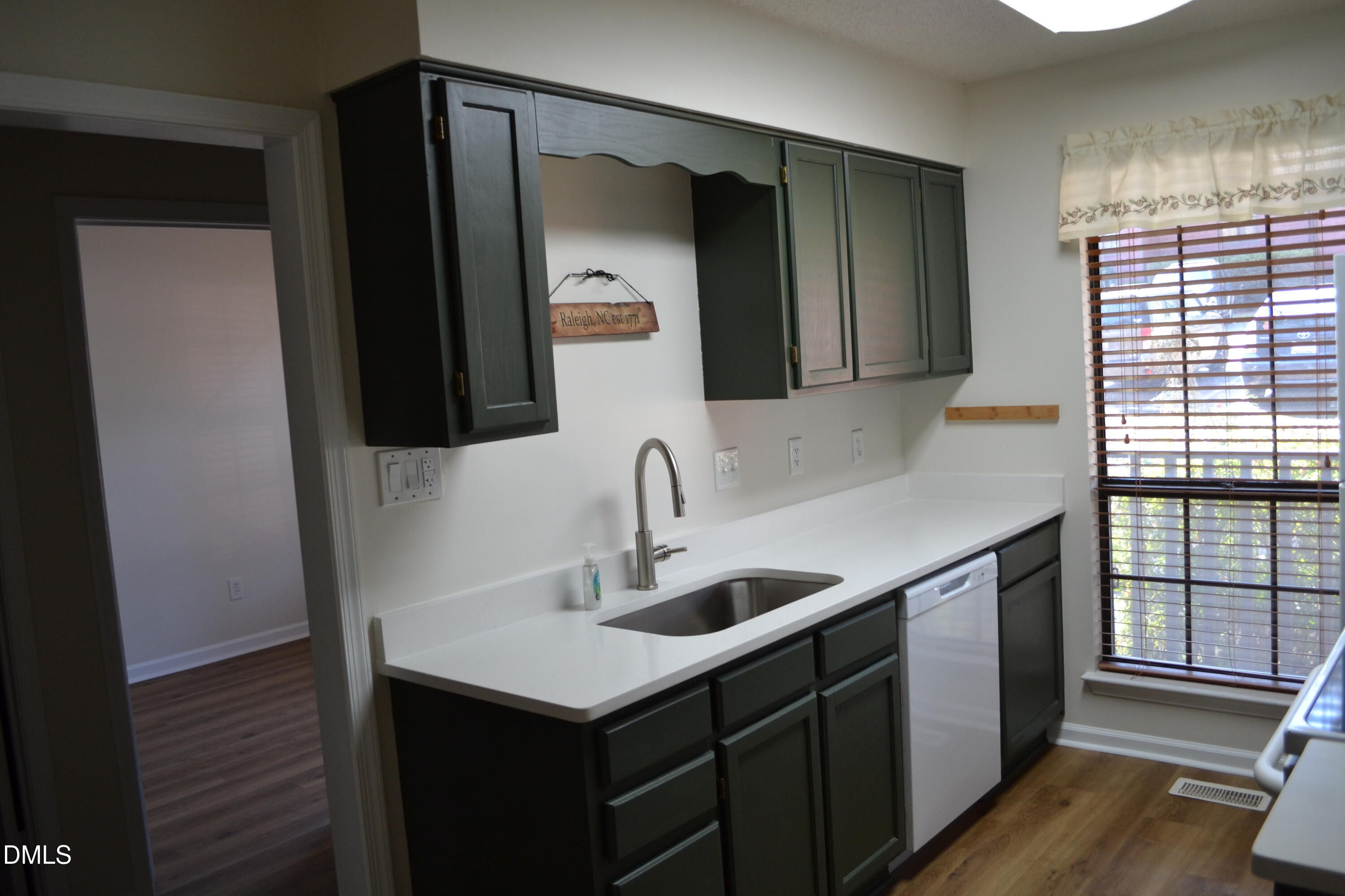 4018 The Oaks Drive Raleigh, NC 27606 - Photo 4 of 49 a kitchen with a sink and a mirror