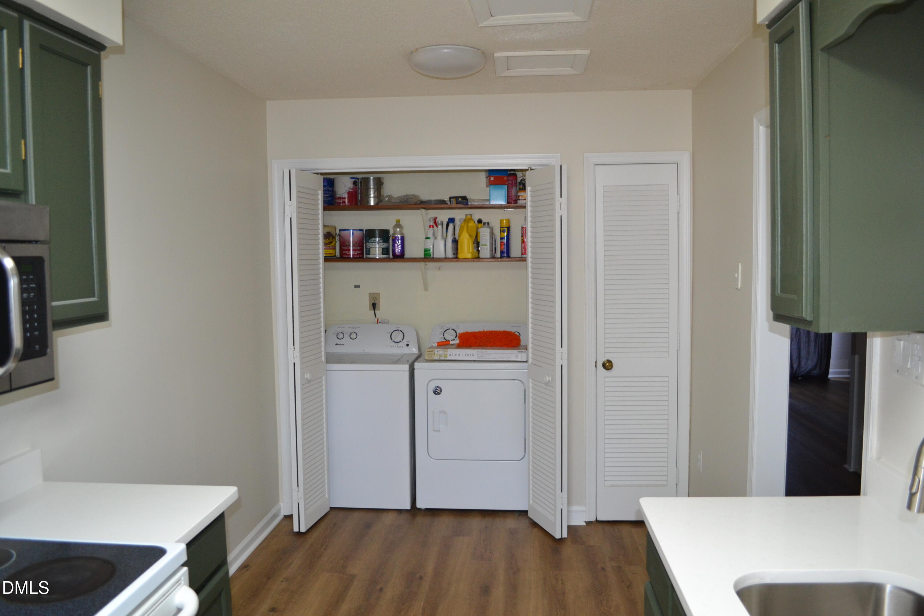 4018 The Oaks Drive Raleigh, NC 27606 - Photo 6 of 49 a room with a wooden floor and cabinets