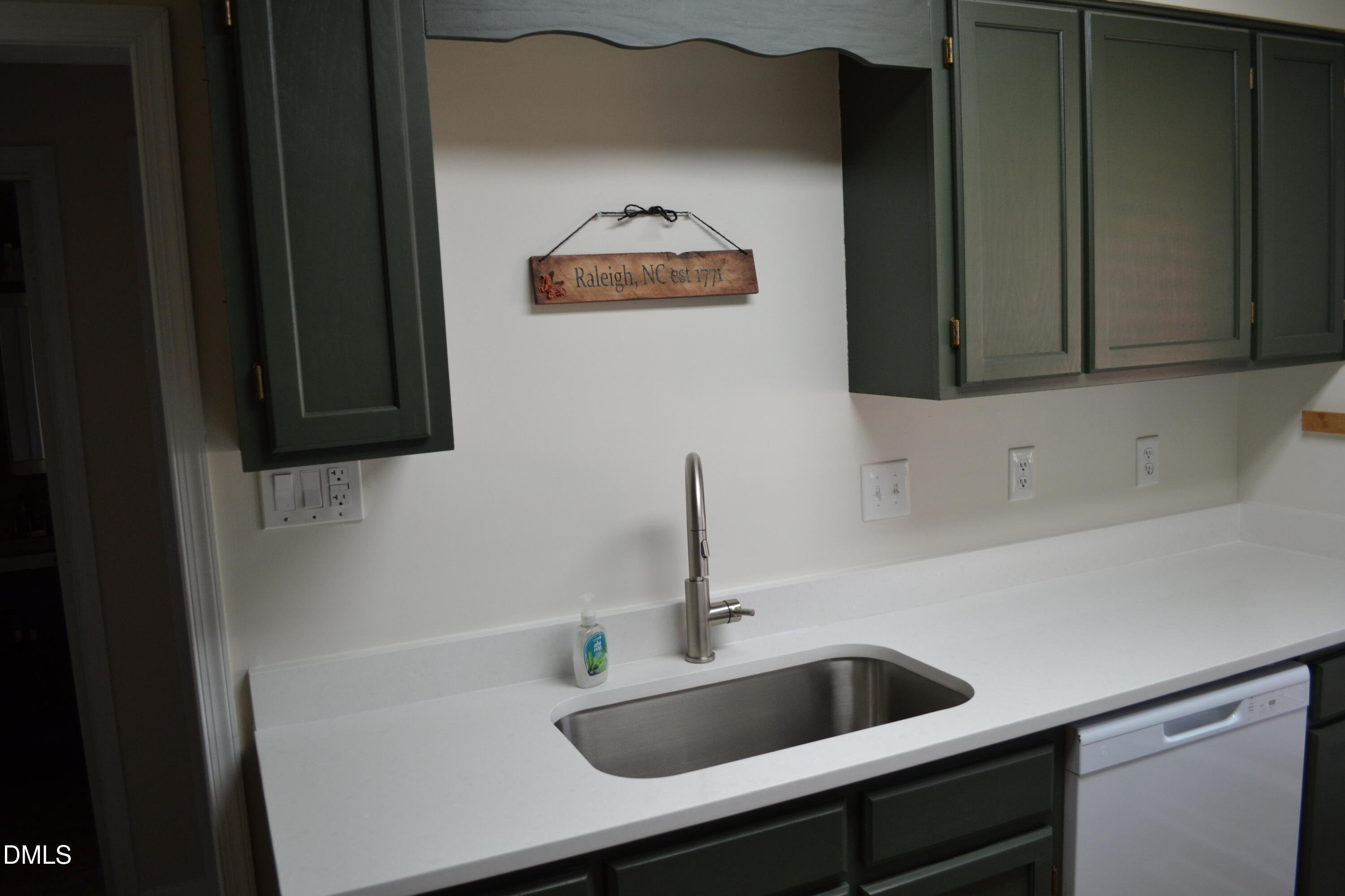 4018 The Oaks Drive Raleigh, NC 27606 - Photo 7 of 49 a bathroom with a sink and a mirror