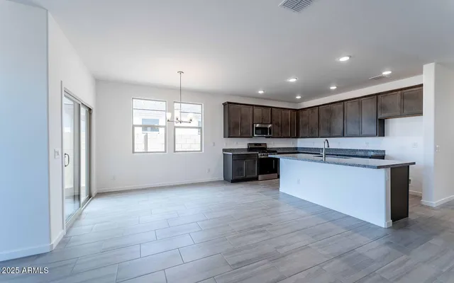a kitchen with granite countertop a stove cabinets and a sink