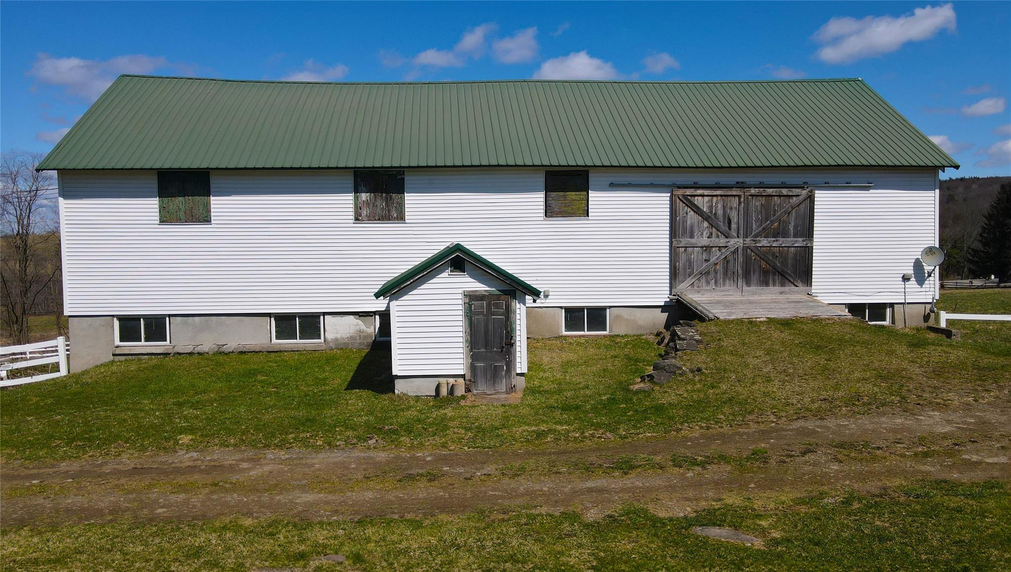 892 Bowbell Road Greene, NY 13778 - Photo 31 of 35 Rear view of property with a metal roof and an outdoor structure