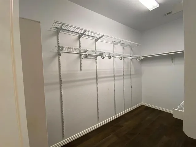 a white toilet sitting next to a white wall