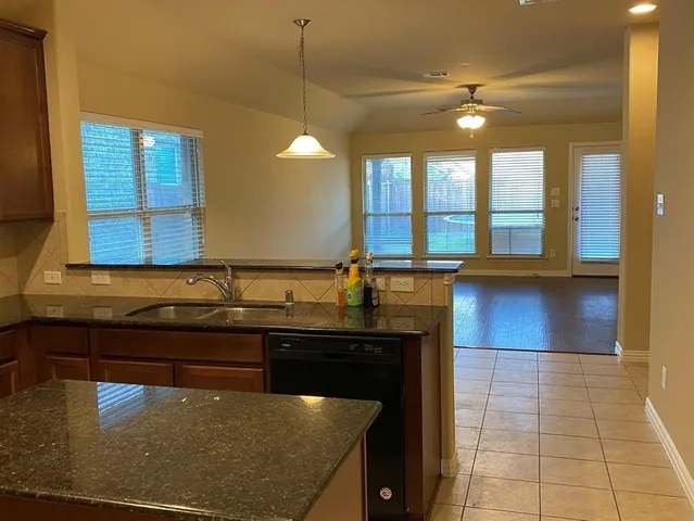 a kitchen with a sink a counter top space and cabinets