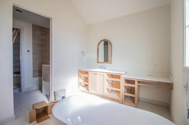 a view of a bedroom with furniture and wooden floor