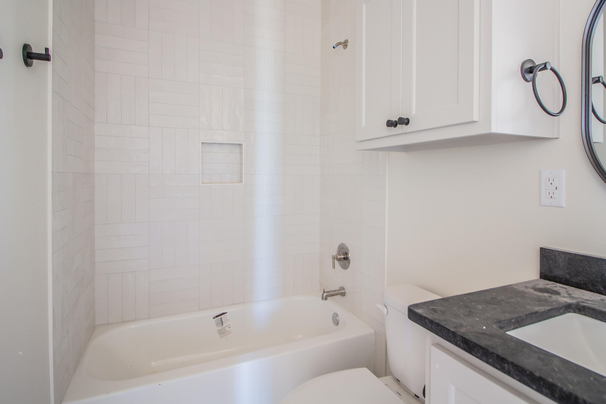 1011 County Road 7715 Lubbock, TX 79423 - Photo 18 of 20 a bathroom with a granite countertop bathtub and a sink