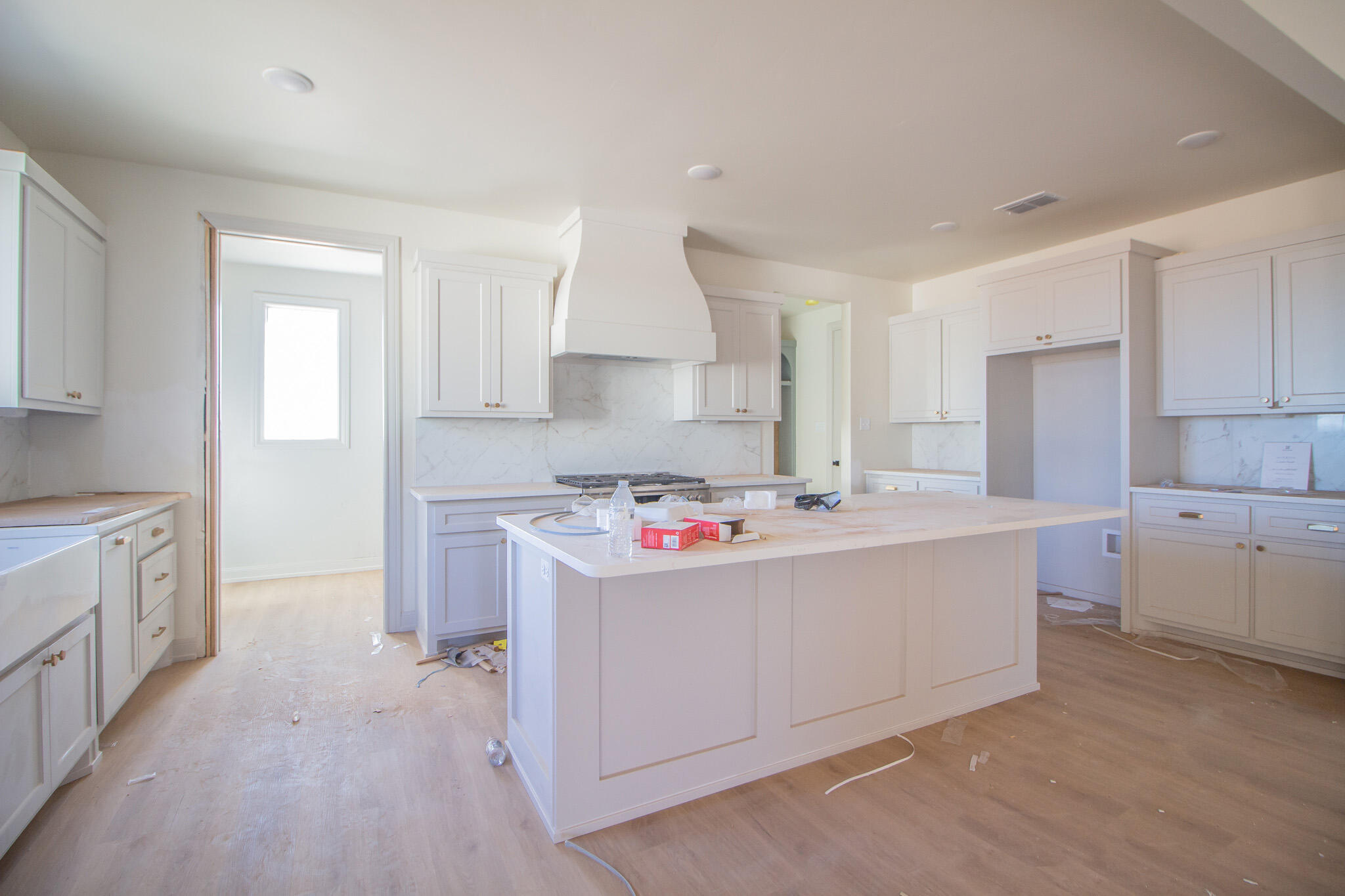 1011 County Road 7715 Lubbock, TX 79423 - Photo 6 of 20 a room with kitchen island a sink a stove and a refrigerator