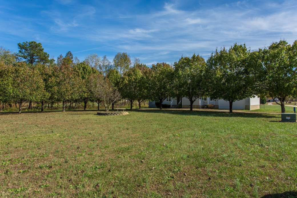 796 Old Eason Road Zebulon, NC 27597 - Photo 9 of 11 Tree lined property with TWO ACRES offers privacy and a peaceful retreat. Exterior Front
