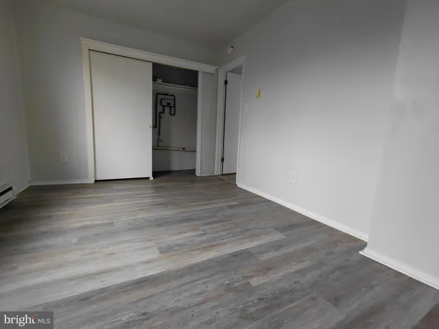 a view of an empty room and wooden floor