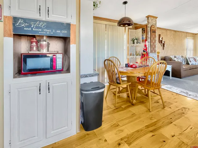 a kitchen with stainless steel appliances granite countertop a sink stove and white cabinets