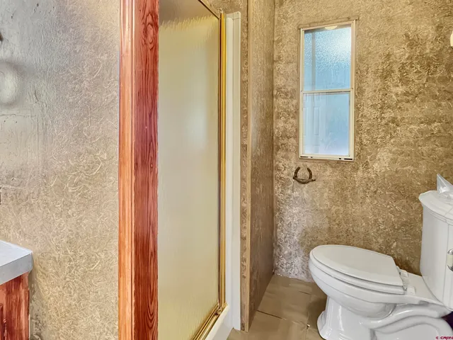 a bedroom with a bed and a night stand