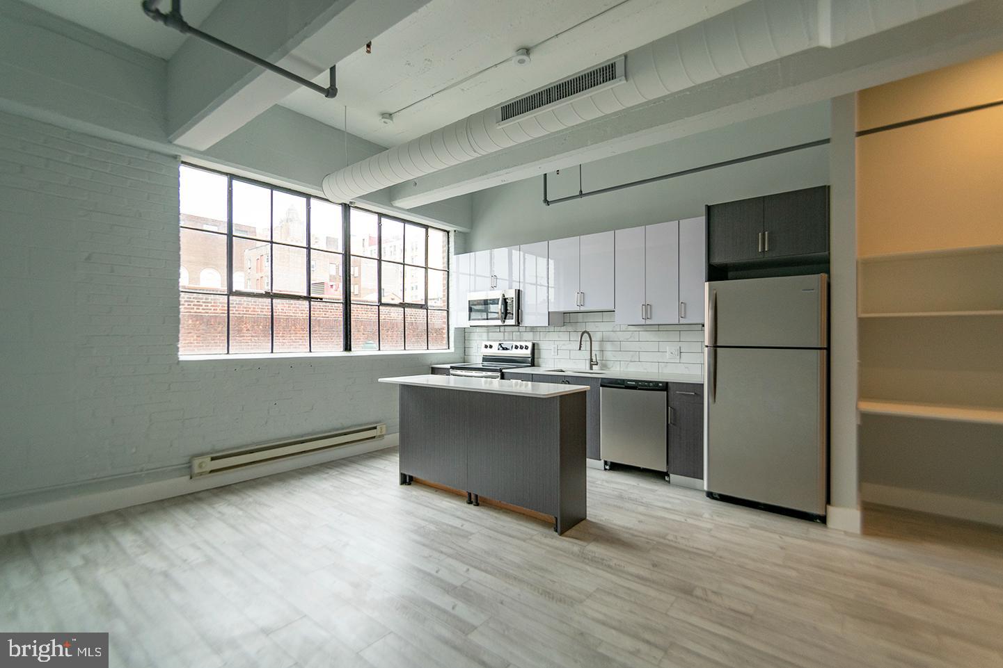 412 South 13th Street, Unit 307 Philadelphia, PA 19147 - Photo 2 of 16 a kitchen with stainless steel appliances granite countertop a refrigerator a sink dishwasher a stove and a refrigerator