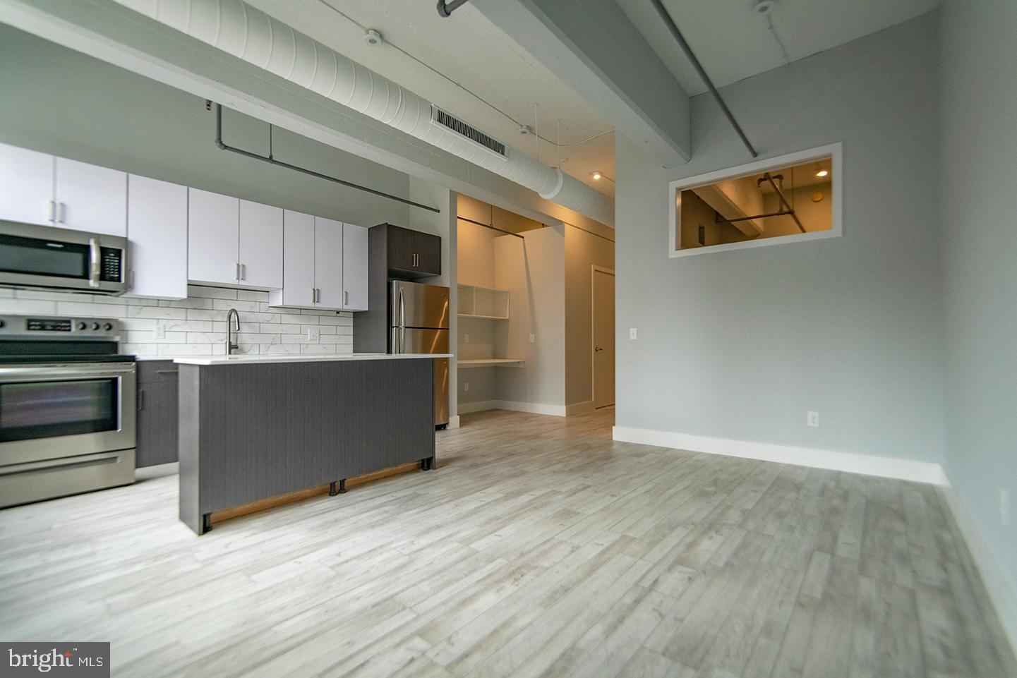 412 South 13th Street, Unit 307 Philadelphia, PA 19147 - Photo 3 of 16 a kitchen with stainless steel appliances a refrigerator and a stove top oven