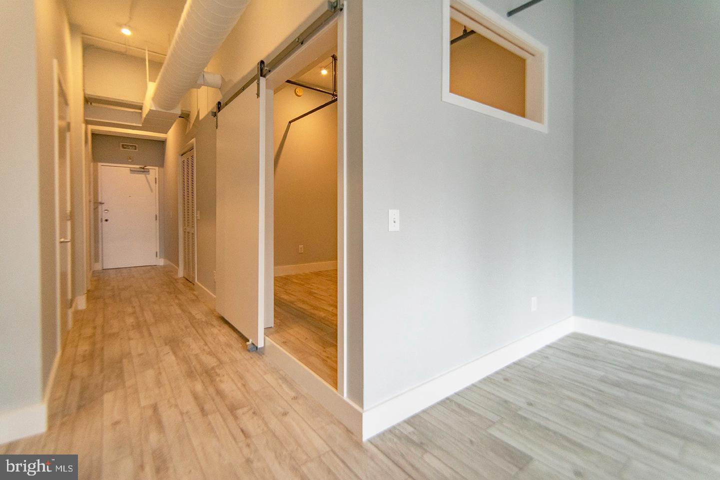 412 South 13th Street, Unit 307 Philadelphia, PA 19147 - Photo 5 of 16 a view of a bathroom with wooden floor and a glass door