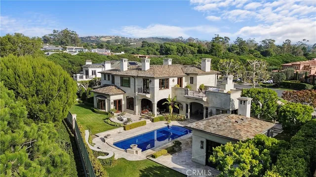 a view of a house with pool and chairs