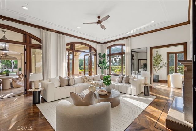 a living room with furniture ceiling fan and a large window