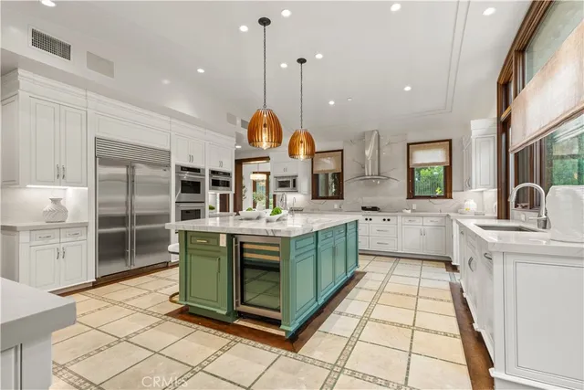 a kitchen with stainless steel appliances granite countertop a sink and a stove
