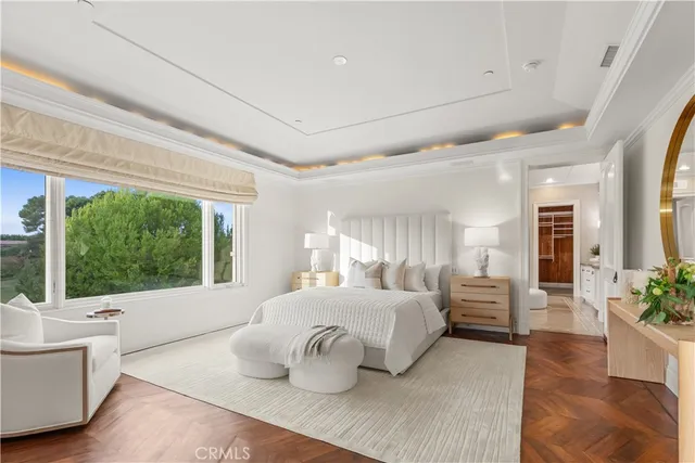 a bedroom with a large bed and a large window