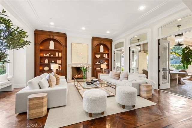a living room with fireplace furniture and a large window