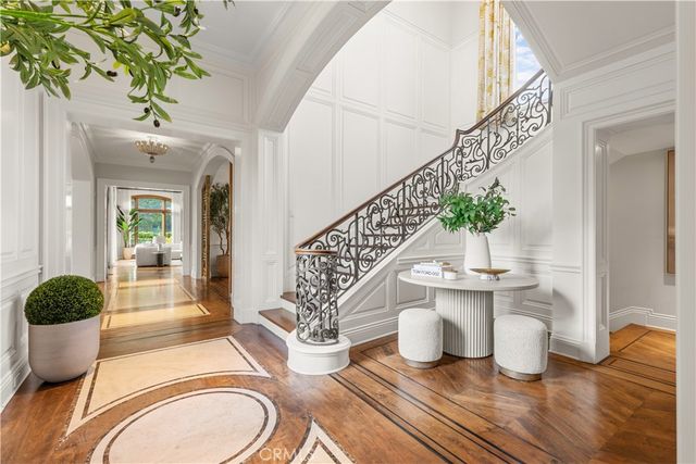 a dining room with wooden floor and a potted plant