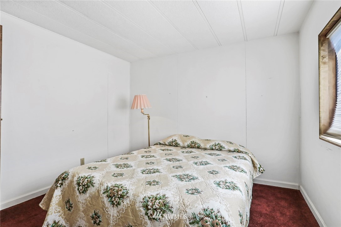 23717 Lake Drive East Bothell, WA 98021 - Photo 22 of 37 a bedroom with a bed and a window