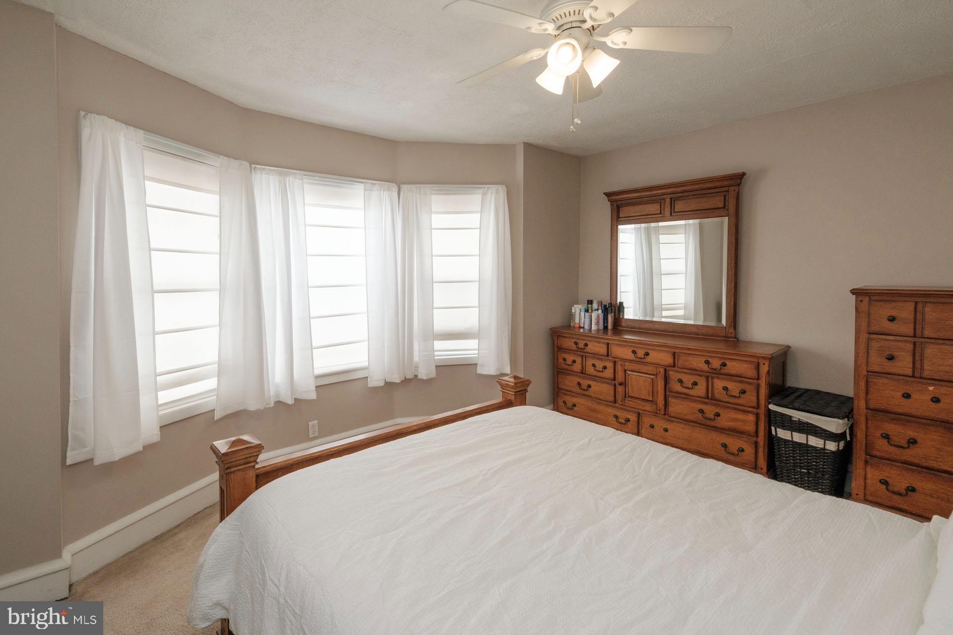 41 North Carroll Street Reading, PA 19611 - Photo 22 of 33 a bedroom with a bed and a dresser with wooden floor