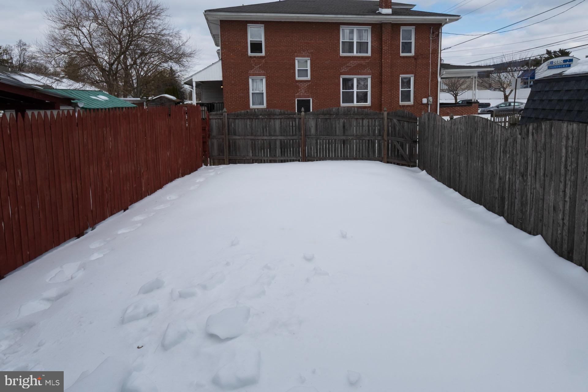 41 North Carroll Street Reading, PA 19611 - Photo 33 of 33 a view of a brick house with a wooden fence