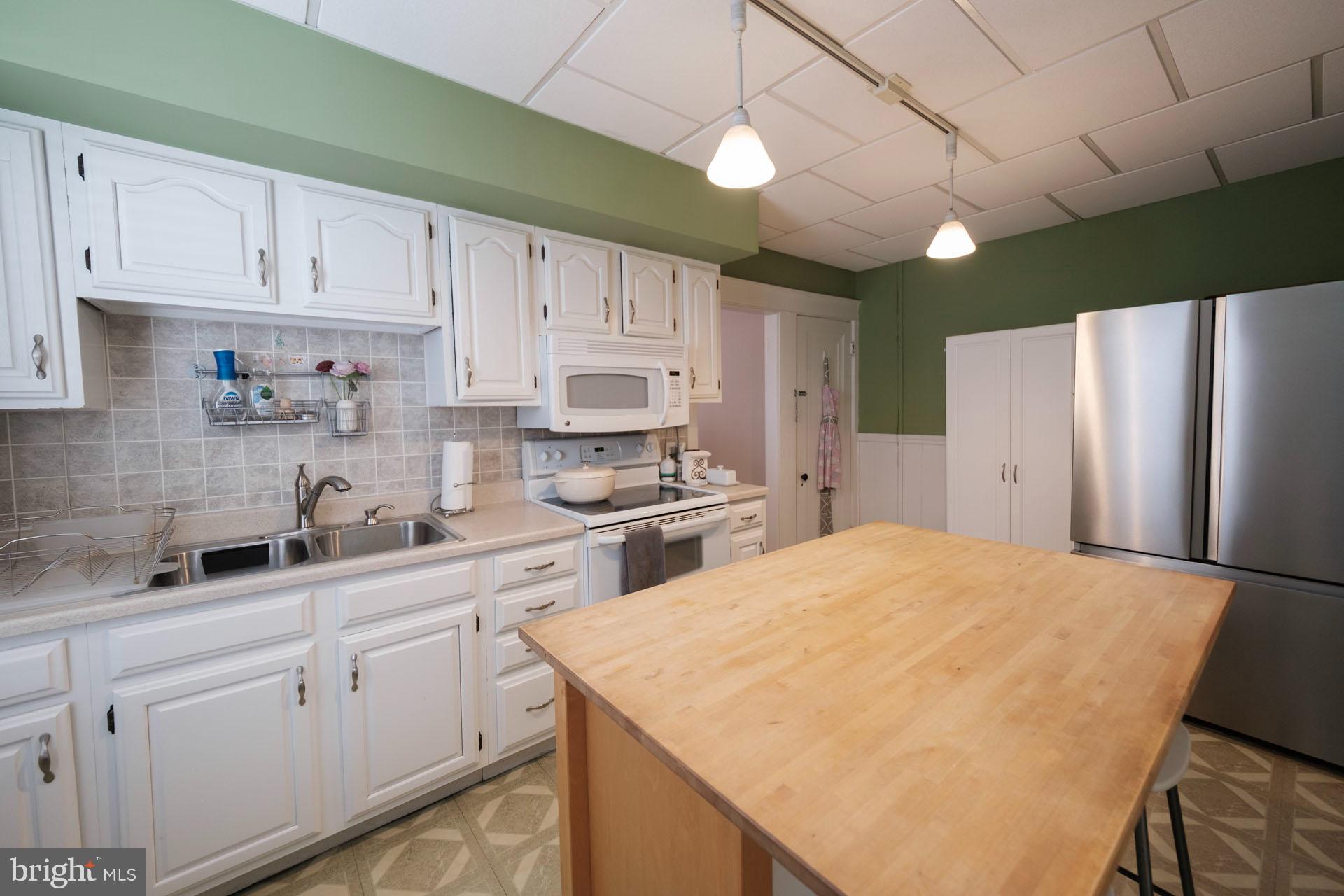 41 North Carroll Street Reading, PA 19611 - Photo 9 of 33 a kitchen with stainless steel appliances white cabinets and a refrigerator