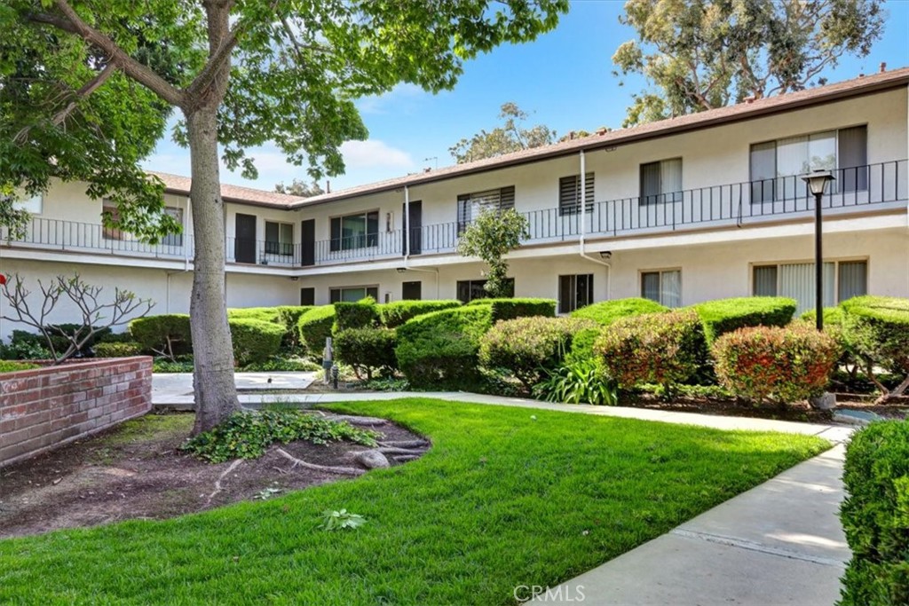 1230 West Lambert Road, Unit 142 La Habra, CA 90631 - Photo 1 of 1 a front view of a house with a yard