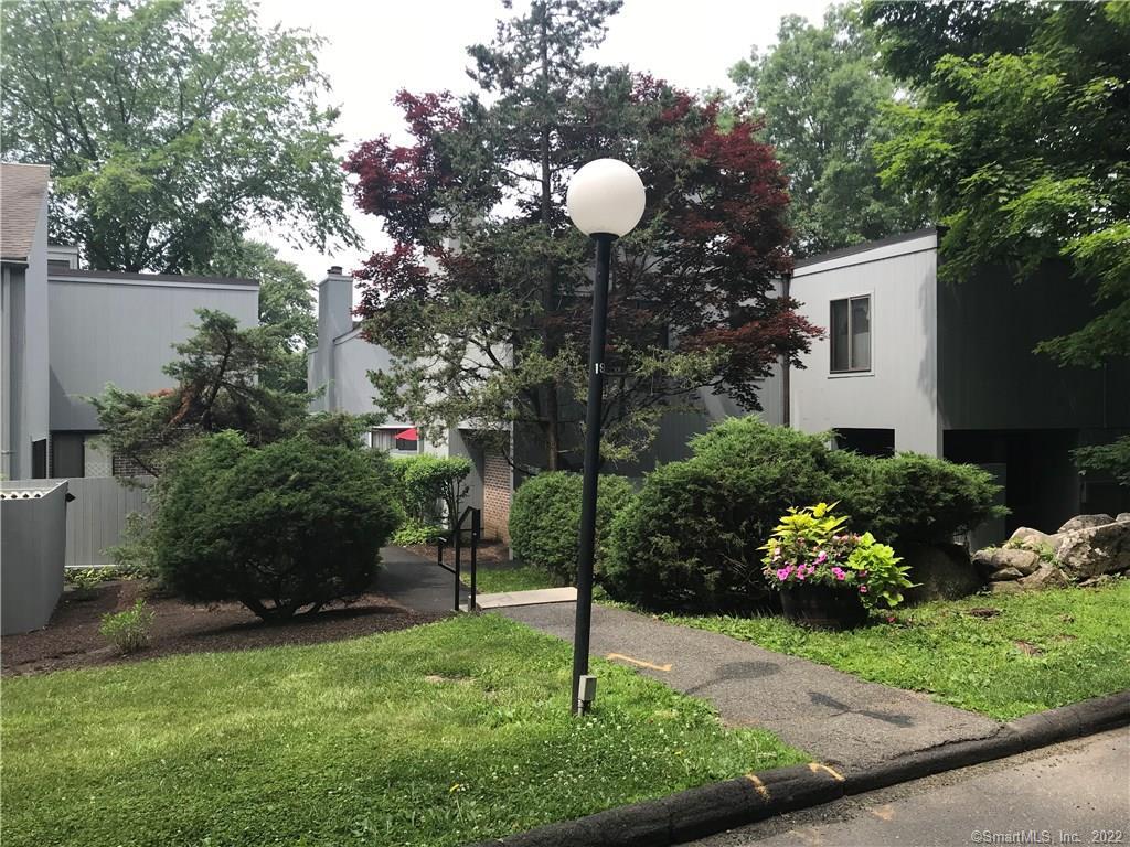 4 Grape Lane, Unit 4 Ridgefield, CT 06877 - Photo 1 of 1 a front view of a house with a yard and outdoor seating