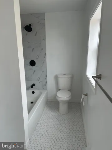 a white toilet sitting next to a bathroom sink