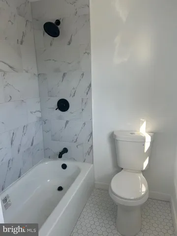 a bathroom with a bathtub and a toilet